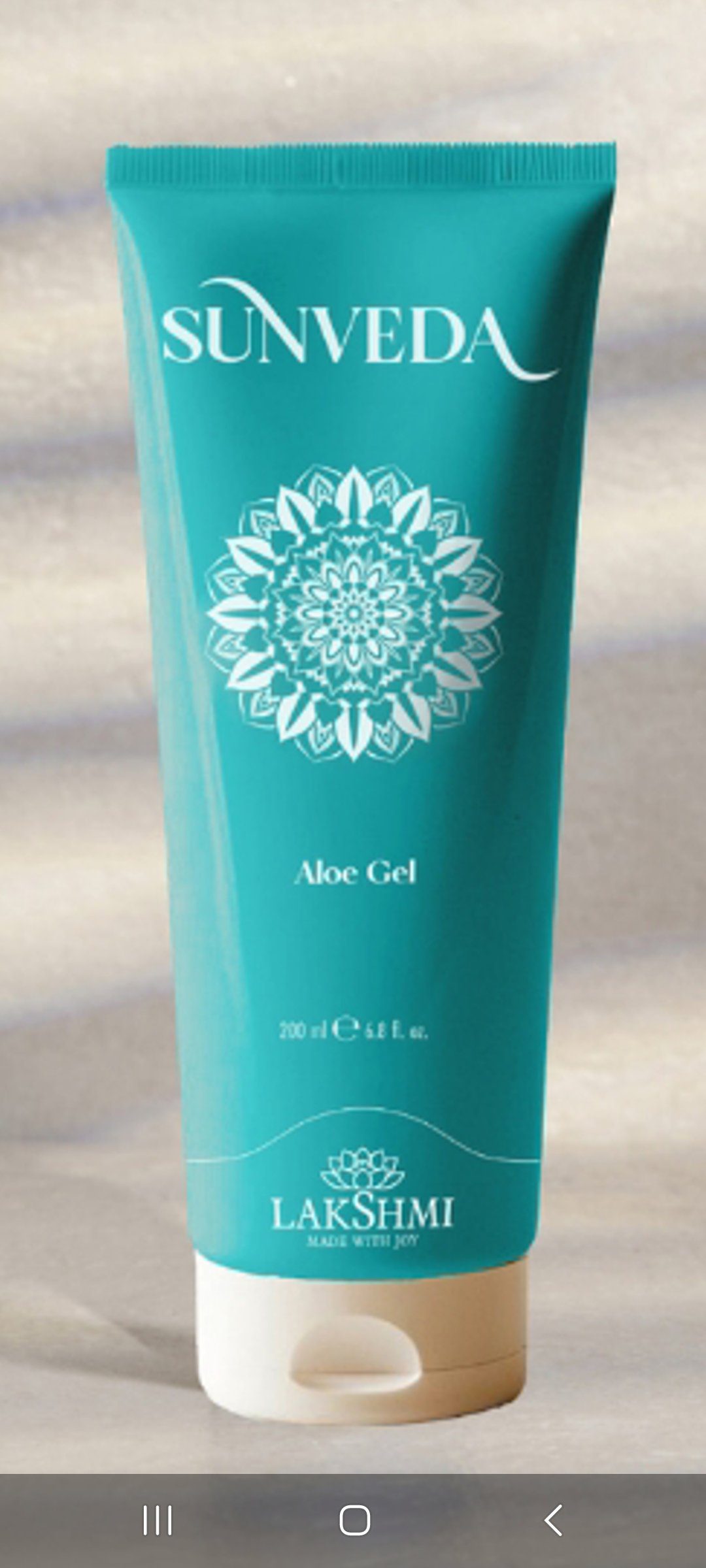 Turquoise Sunveda Aloe Gel tube with white mandala design and Lakshmi logo on a neutral background.